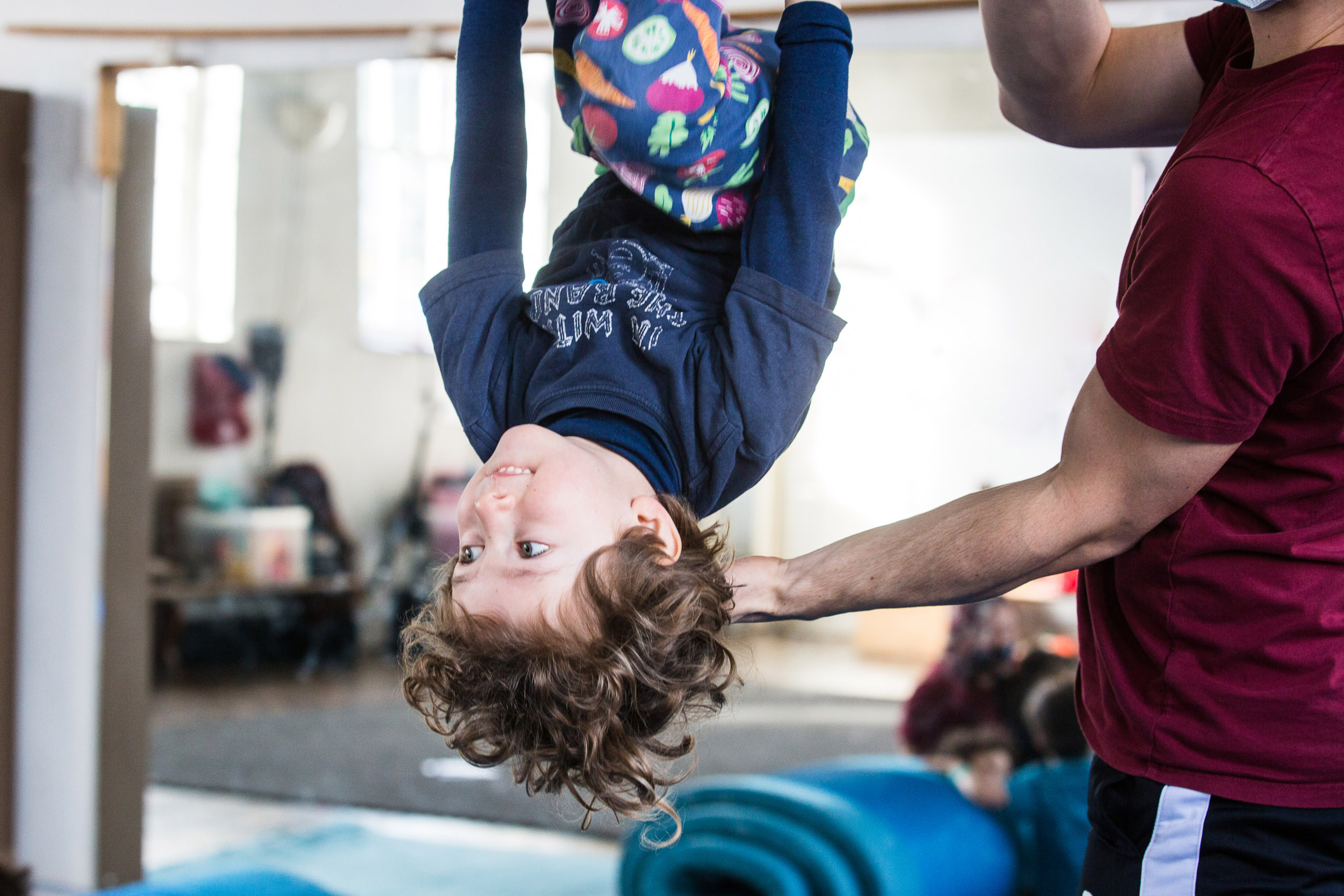 Youth Circus trapeze upside down